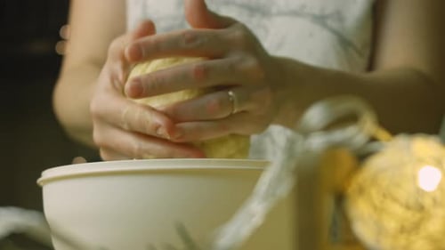 Woman Kneading Dough in a Bowl at Home