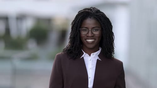 Front View of Smiling Woman with Dreadlocks Looking at Camera