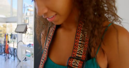 Model holding camera in photo studio 4k