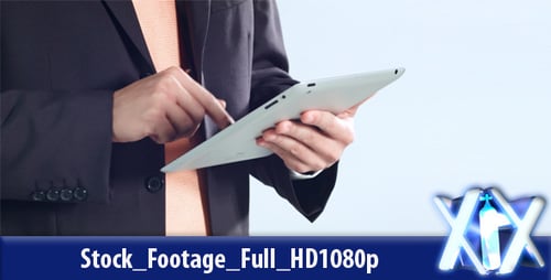 Man in Suit Using Touchscreen Tablet