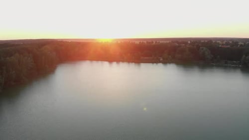 Calm Lakes and Plain Fields with Sun in Background