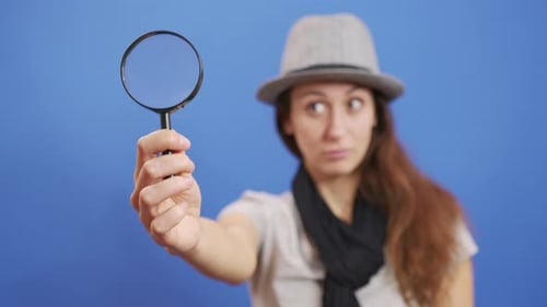 Funny Girl Looking Throw Magnifier To the Camera