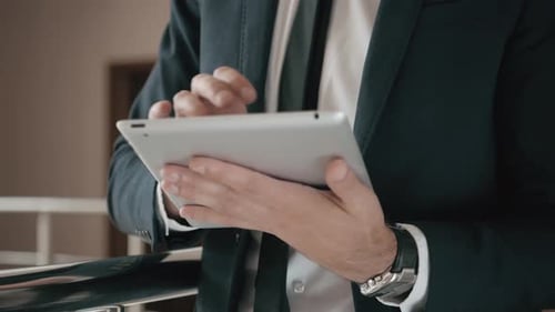 Close Up of Man Using a Tablet for His Work