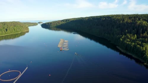 Boat Pulls Up to Pools For Trout On The Fish Farm