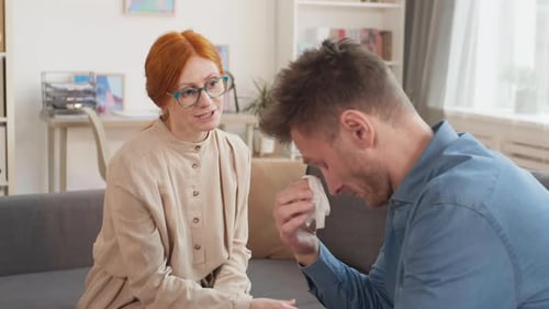 Woman Calming Crying Man Down