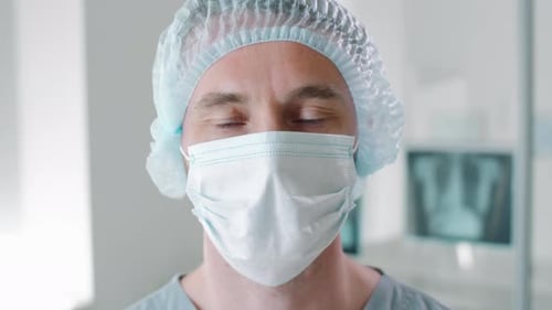 Doctor Wearing Mask and Surgical Cap in Hospital