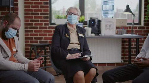 Adults Attending Group Therapy Session in Office