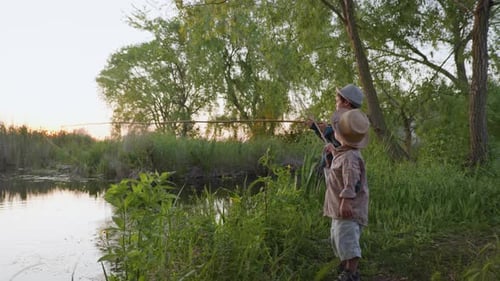 Happy Childhood, Healthy Joyful Male Children Enjoy Summer Vacation Fishing on River Bank at Rural