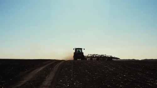 Tractor with Cultivator Turn Around on the Field