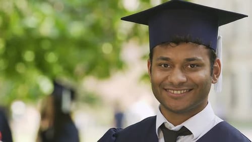 Biracial student happily showing his diploma, international education system