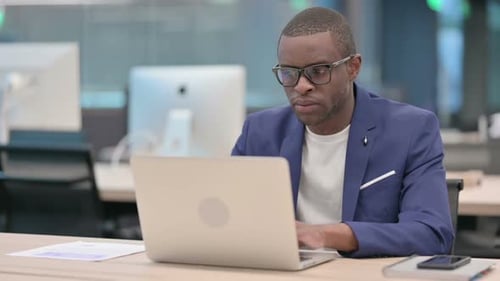 Young African Businessman Working on Laptop in Office