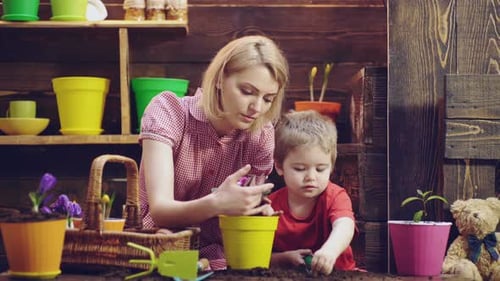 Mother and Child Planting Flowers Together Indoors