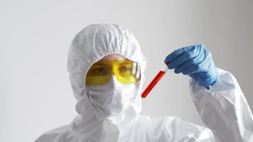 Scientist Holds Test Tube in Protective Suit