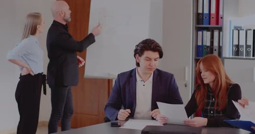Business Colleagues Discussing Strategy in Office