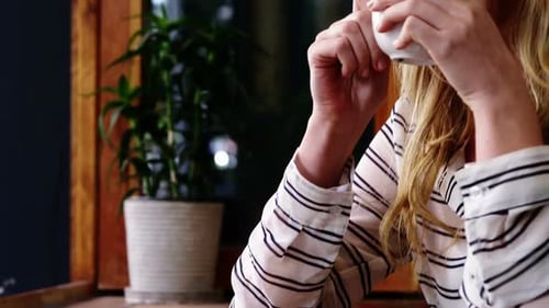 Woman having coffee in cafe