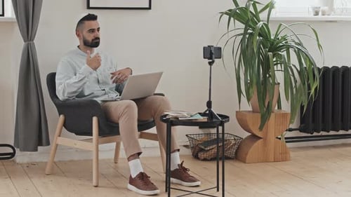 Man with Laptop on Video Call from Home