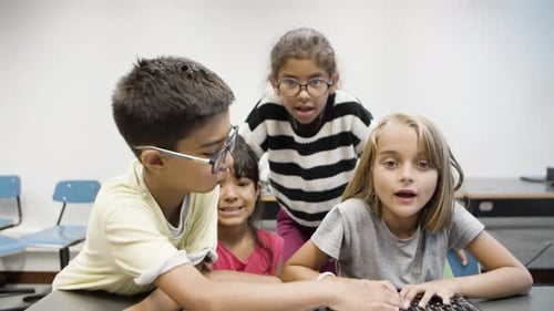 Multiethnic Children Having Fun During Computer Science Lesson