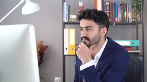 Man Working at Computer in Modern Office