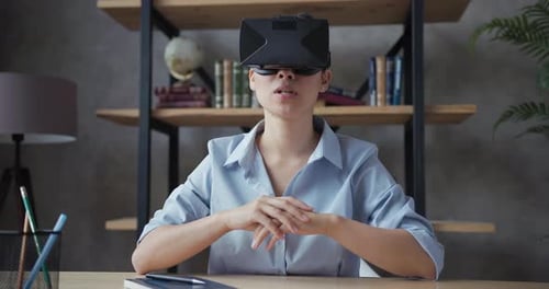 Woman at Desk Using Virtual Reality Headset