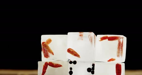 Ice Cubes with Peppers and Peppercorns Melting