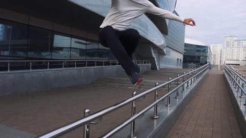 Man Performs Parkour Tricks in Urban Setting