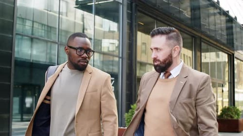 Multiethnic Male Colleagues Walking in Downtown and Chatting