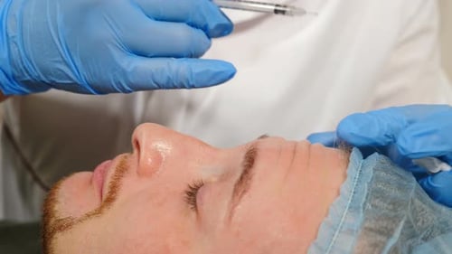 Man Receives Facial Injection from Medical Professional