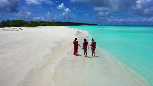 Ladies tanning on marine sea view beach vacation by blue lagoon and white sandy background of the Ma