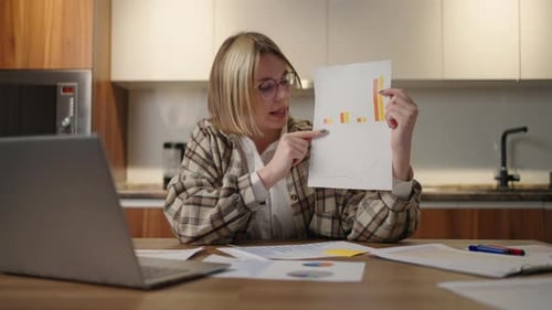 Woman Presents Bar Graph During Remote Work