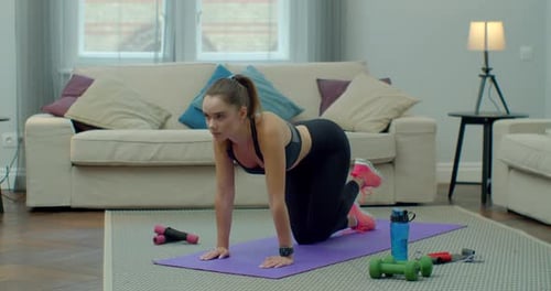 Woman Doing Leg Lifts on Yoga Mat Indoors
