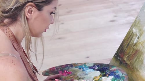 Professional Girl Artist Oil Paints on Canvas. Details, Side View