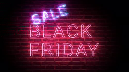 Glowing Neon Sale Black Friday Sign on Dark Brick Wall
