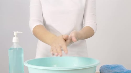 Person Thoroughly Washing Hands with Foaming Soap