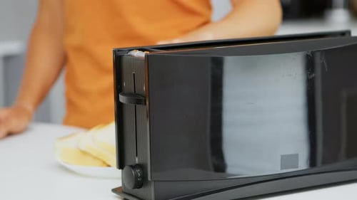 Toast Being Placed Into a Toaster