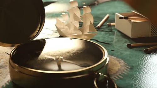 Animated Paper Ship and Golden Compass on Old Map