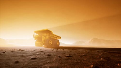 Industrial Mining Haul Truck Driving Through Desert at Sunset