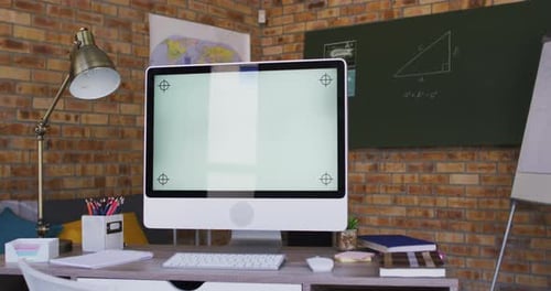 View of computer and other school supplies on table in the classroom at school