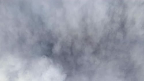 Aerial View From High Altitude of Earth Covered with Puffy Rainy Clouds Forming Before Rainstorm