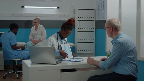 Doctor Explains Diagnosis to Patient with Digital Tablet