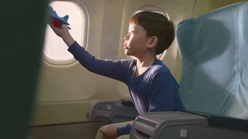 Boy with Toy Airplane on Plane
