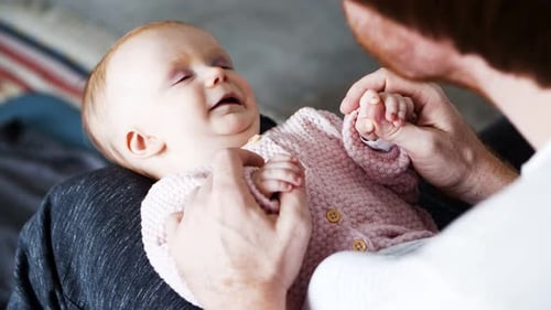 Dad Playing with Joyful Baby Daughter