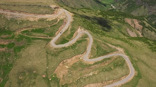 Cars passing through curve in mountain road. Mountain serpentine road