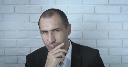 Thoughtful Man in Suit Thinking Deeply