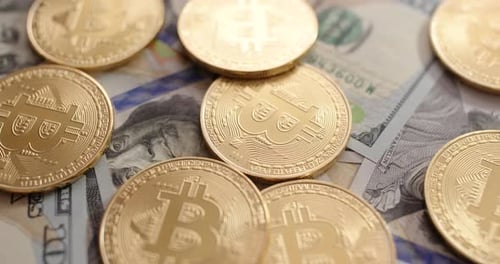 Bitcoin Coins on US Dollar Bills Close Up