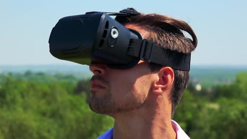 Man Wearing VR Headset in a City Park