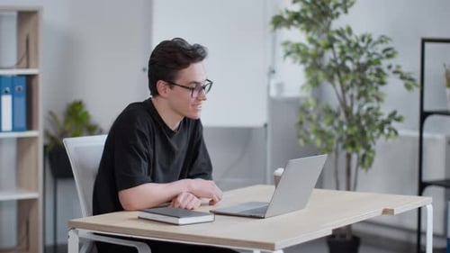 Young Adult on Video Call in Office