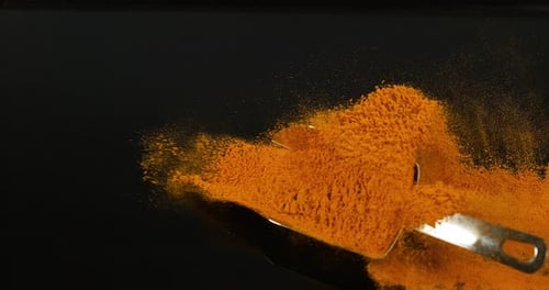 Turmeric, curcuma longa, Powder falling against Black Background, Indian Spice, Slow Motion 4K