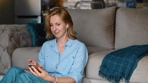 Woman Relaxing and Listening to Music at Home