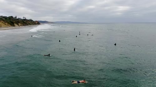 Aerial View of Surfers Waiting, Paddling and Enjoying Waves