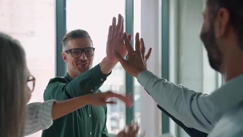 Happy Team Giving High Five at the Office